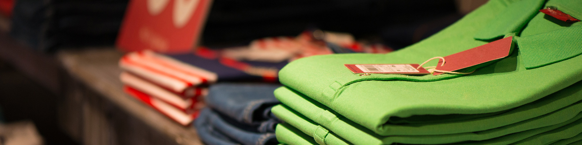 Colorful golf shirts folded and kept on shelf